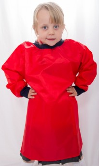 Little girl wearing a red paint smock